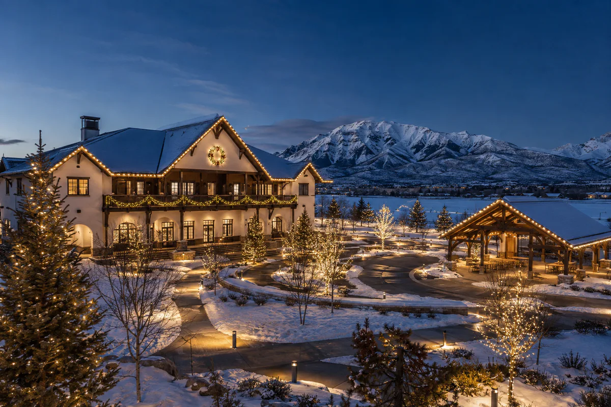Swiss-inspired Midway community clubhouse and event courtyard with professional gable, garland, tree, and pathway holiday lighting